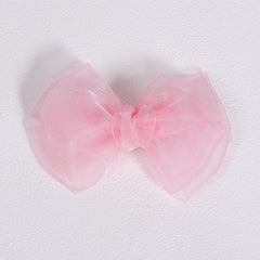 KCHIES bow paired with a party dress illustrating outfit coordination and elegance