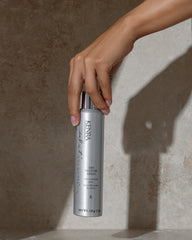 Kenra two 5.3 oz cans in hand showing compact travel-friendly size