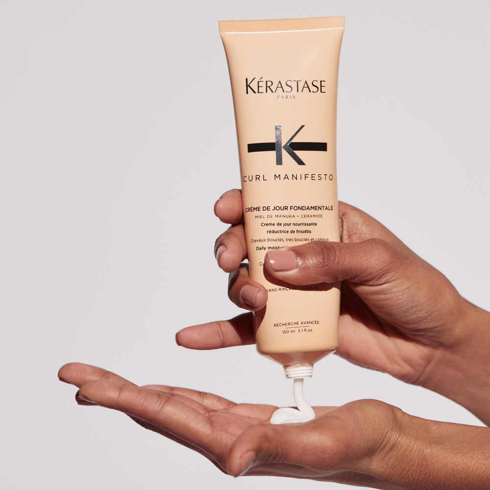KÉRASTASE held in hand next to ruler for size context and travel convenience