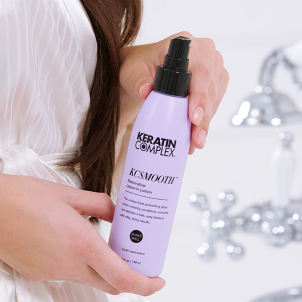 Keratin Complex bottle beside hand to show 5 fl oz travel-friendly size benefit
