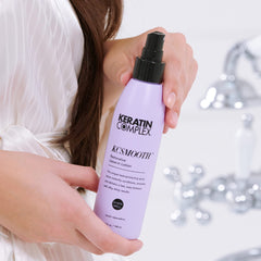 Keratin Complex bottle beside hand to show 5 fl oz travel-friendly size benefit