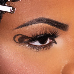 Kimchi Chic brown liner swatch on skin showing rich pigment and smooth glide
