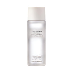 KISS bottle beside hand to show 50 ml travel-friendly size