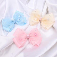 Kiszu bow on ponytail demonstrating tidy, decorative hold