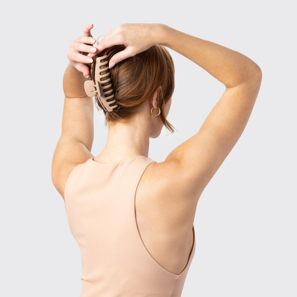 Kitsch clips styled in hair on the beach for wind-resistant, travel-ready hold