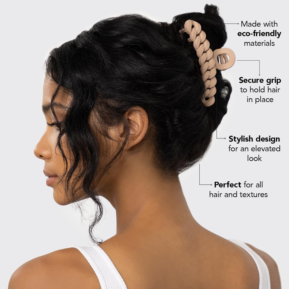 Kitsch clip held in hand to show scale and strong hold for thicker hair