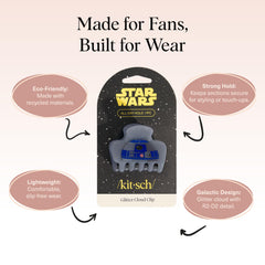 Kitsch R2-D2 held in hand demonstrating compact scale