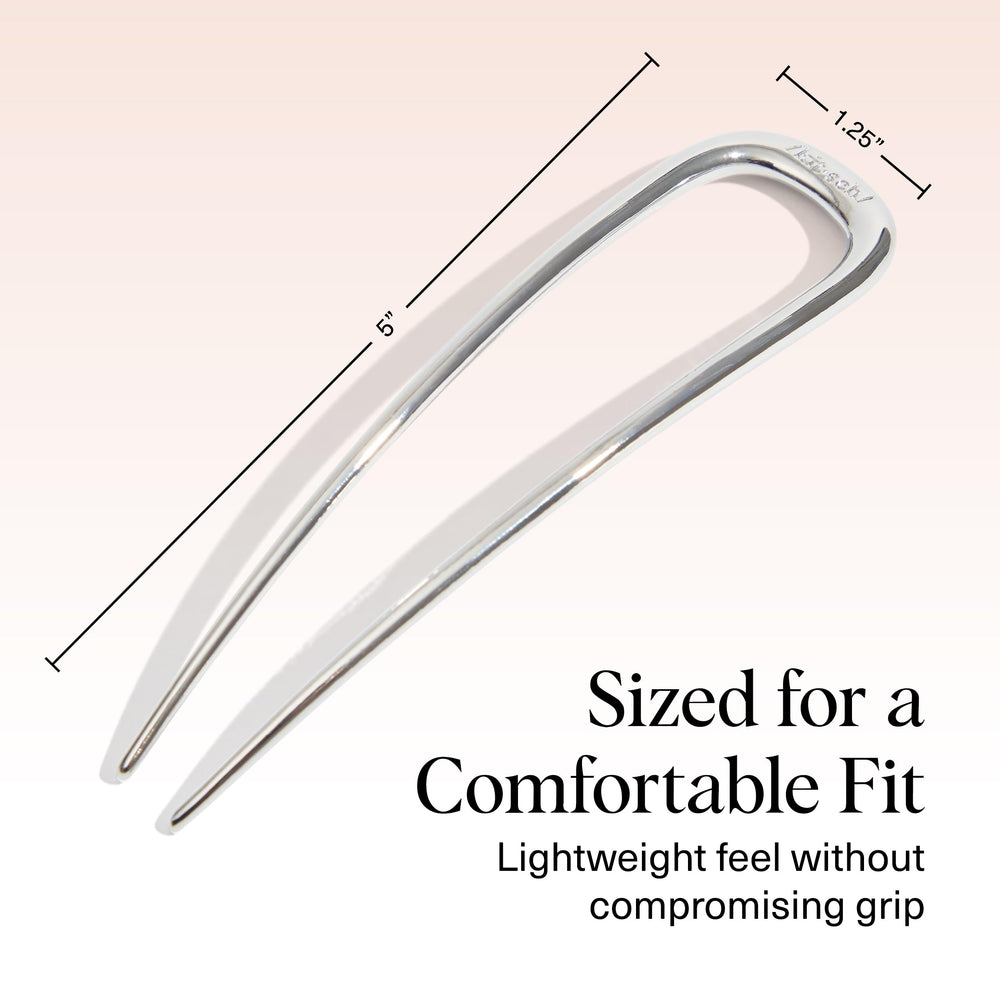Kitsch hair pin next to coin size comparison for portability and travel ease