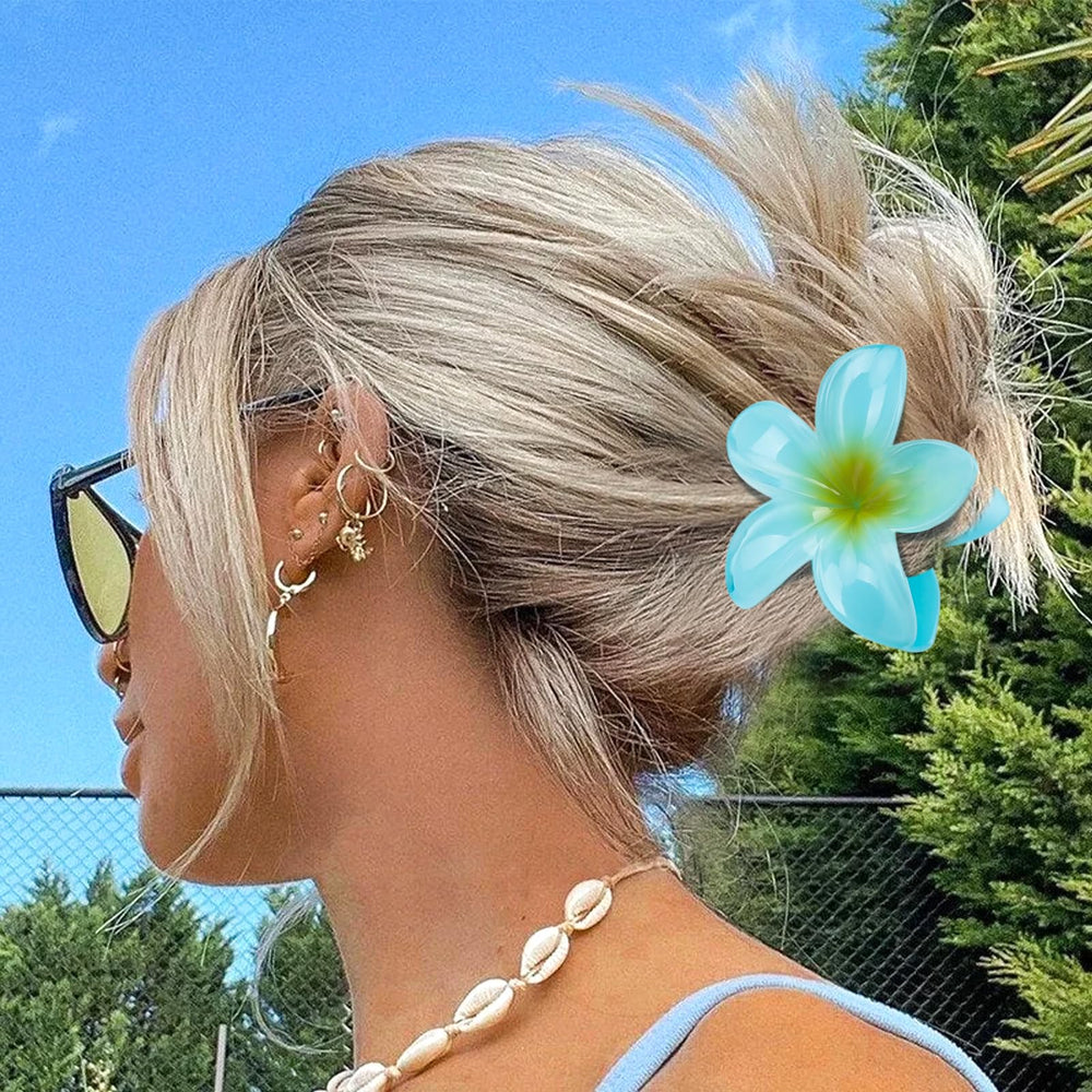 Kivzex plumeria worn in half-up hairstyle, secure hold and stylish tropical look