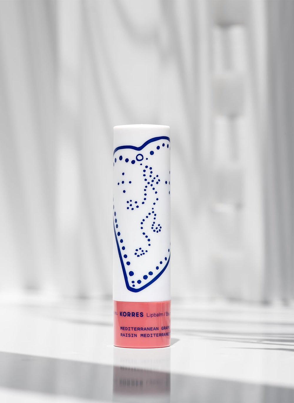 KORRES Lip Butter Stick applied on lips in lifestyle scene for easy touch-ups