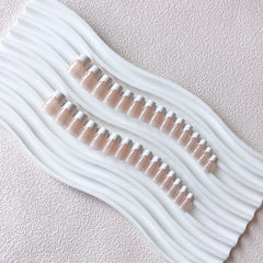 KQueenest kit contents with glue and tabs for complete at-home manicure