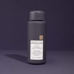 Kristin Ess purple conditioner swatch on hand illustrating pigment strength