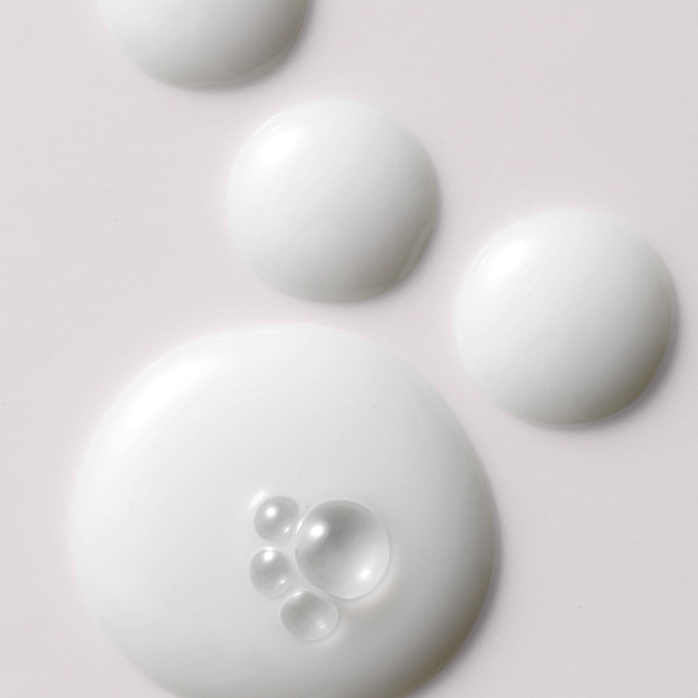 Kristin Ess milk oil pouring to reveal silky texture and quick absorption