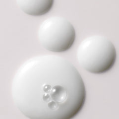 Kristin Ess milk oil pouring to reveal silky texture and quick absorption