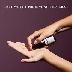 Kristin Ess applying serum to damp hair demonstrating heat-protectant prep benefit