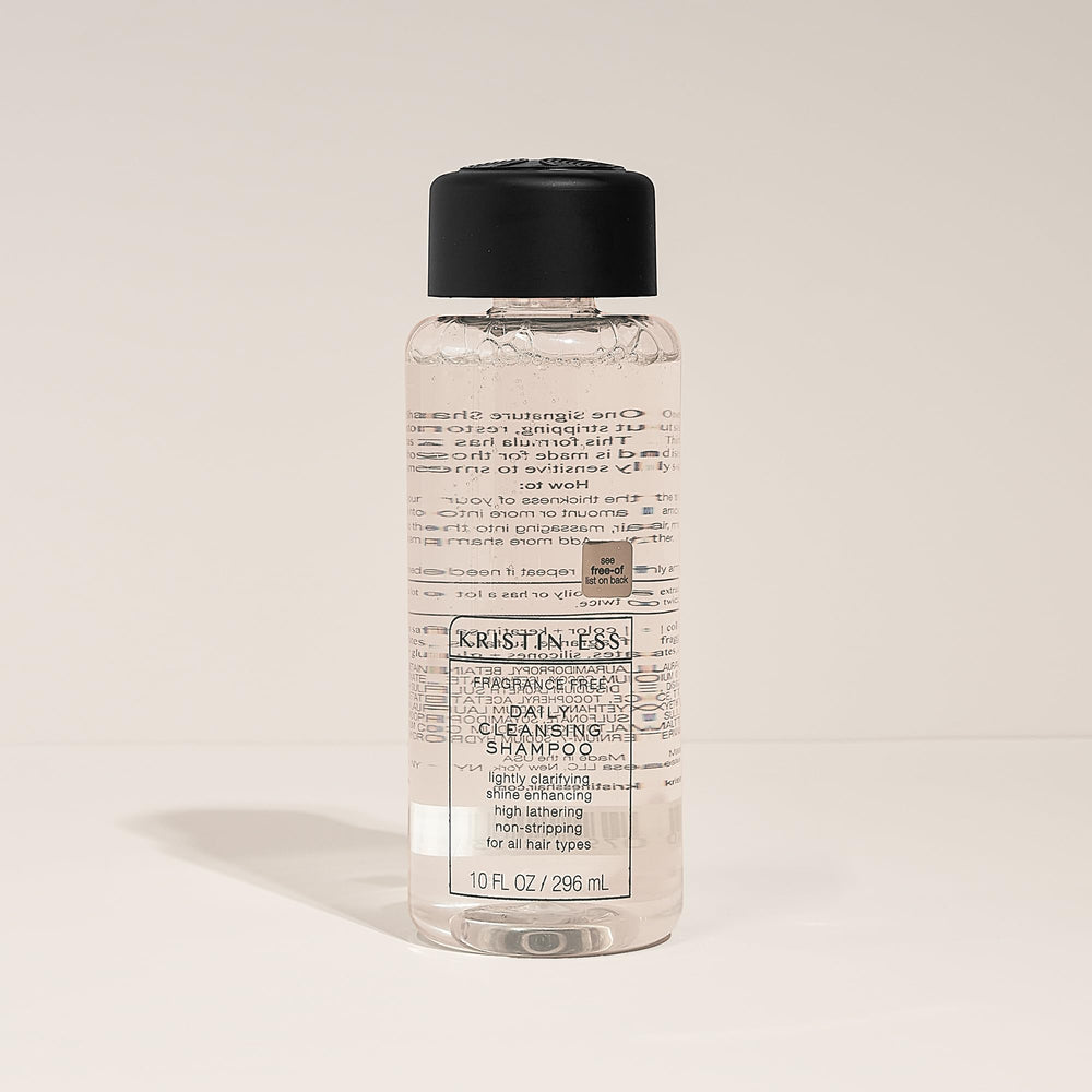 Kristin Ess bottle beside a ruler showing 10 fl oz size