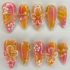 KRTBKR front view showing orange 3D floral press-on nails, quick glam