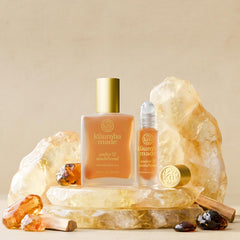 Kuumba Made bottle next to travel items showing compact, airline‑friendly convenience