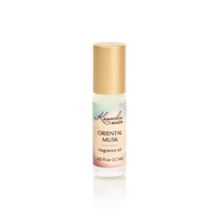 Kuumba Made front bottle shot showing label and compact roller, travel-friendly scent