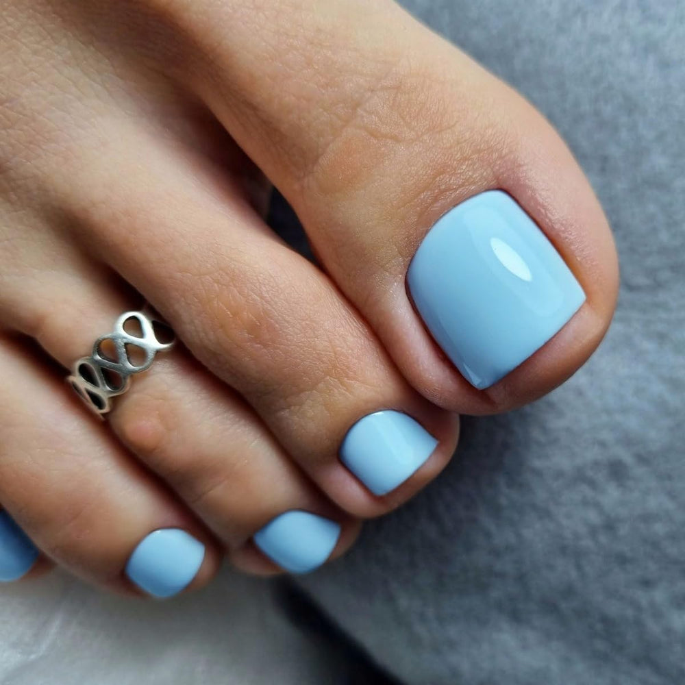KXAMELIE close-up of glossy sky blue nail surface highlighting smooth finish