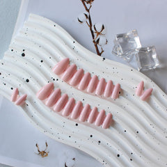 KXAMELIE nails styled on dresser conveying event-ready polished look