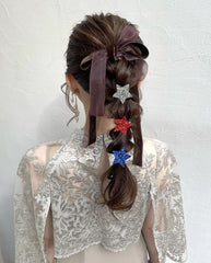 KZBTRBT clip worn in half-up hairstyle, adds patriotic sparkle