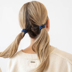 L. Erickson in gym use holding hair secure during active movement