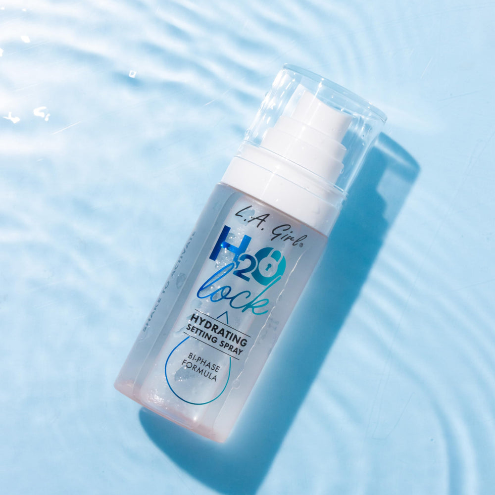 L.A. Girl model spraying mist for fresh dewy look benefit