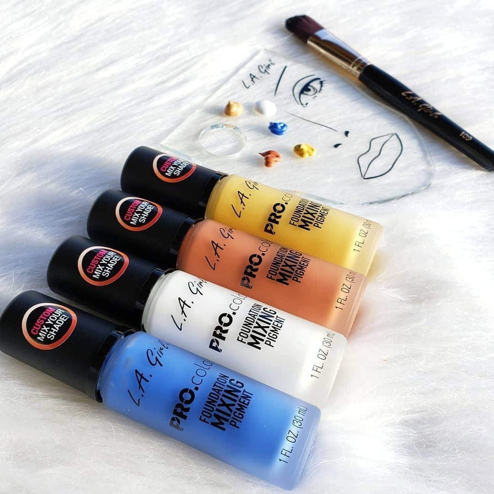 L.A. Girl drop of orange pigment into foundation demonstrating mixing ease