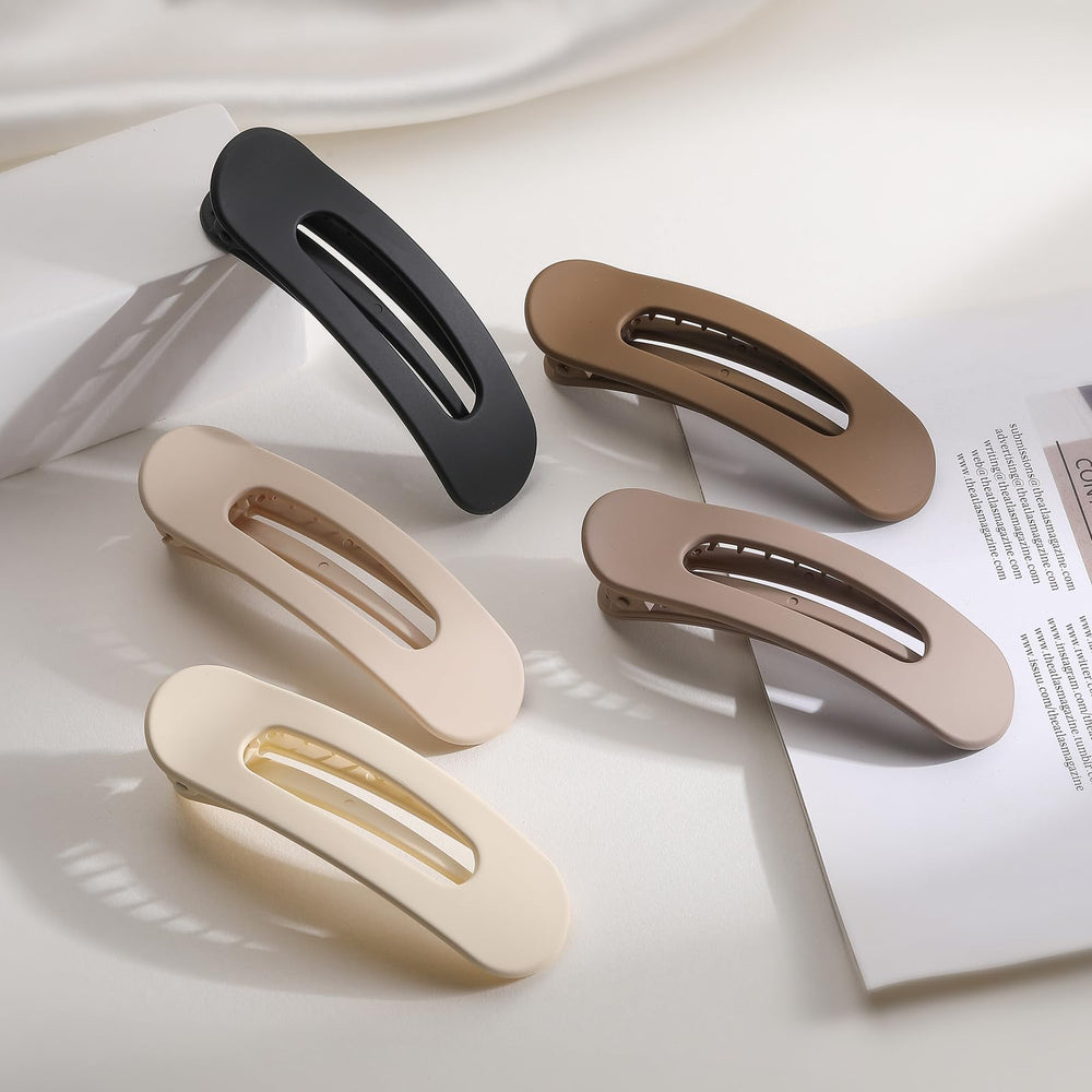 Lahnie clip next to a hand for size comparison and travel-friendly convenience