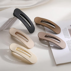 Lahnie clip next to a hand for size comparison and travel-friendly convenience