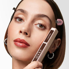 Lancôme Lash Idôle next to hand shows size and travel-friendly portability