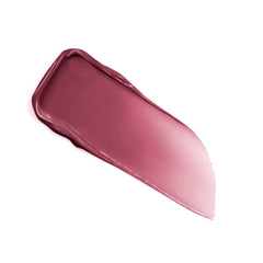 Lancôme balm next to hand showing compact size and travel-friendly benefit