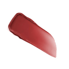 Lancôme lip idôle beside coin for scale showing compact size and travel-ready benefit