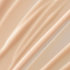 Lancôme Trésor lotion close-up of pump dispensing cream, quick-absorbing texture for silky skin