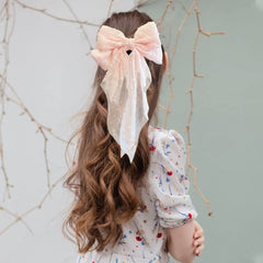 LAPOHI bow worn in hair side profile adding feminine flair and visible charm