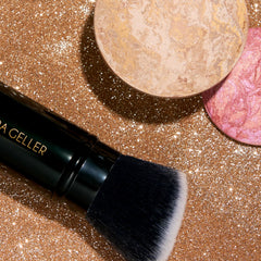 LAURA GELLER powder foundation swatch on medium skin for natural coverage benefit