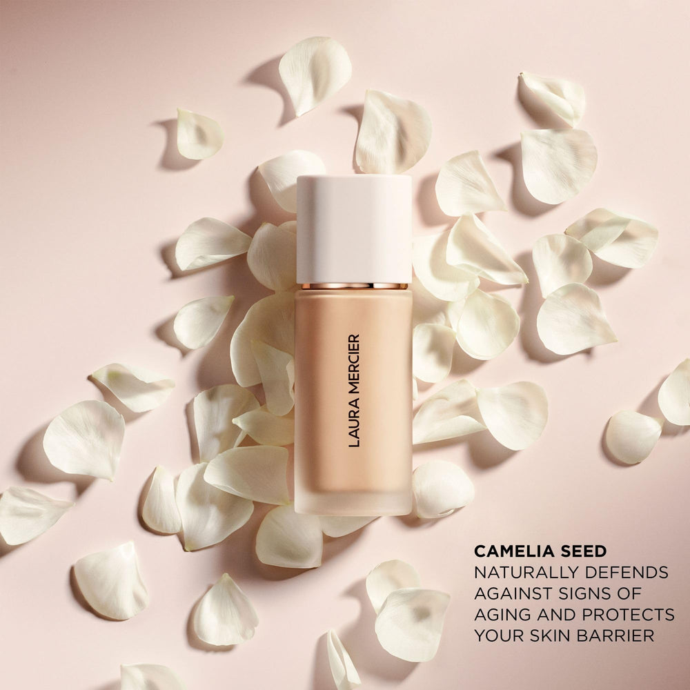 Laura Mercier bottle with brush and sponge lifestyle scene for routine