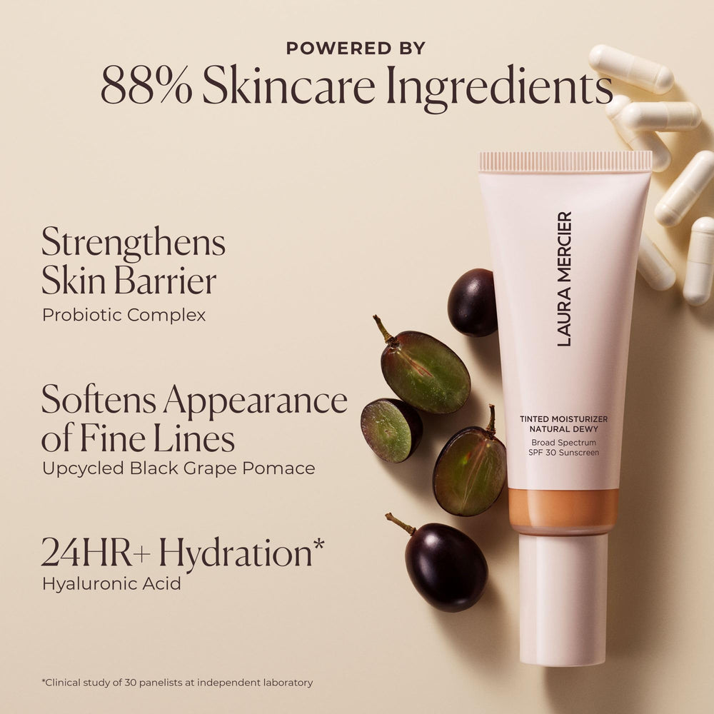 Laura Mercier product beside coin showing compact size and travel ease