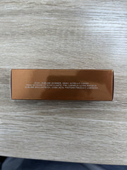 Lezero bottle held in hand for size reference showing 1oz portability and travel-friendly benefit