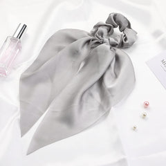 LFOUVRE ribbon wrapped around bun benefit: creates neat updo detail