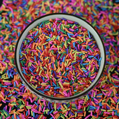 LIKETURE sprinkles beside a coin for scale to demonstrate small sizes and precise craft application