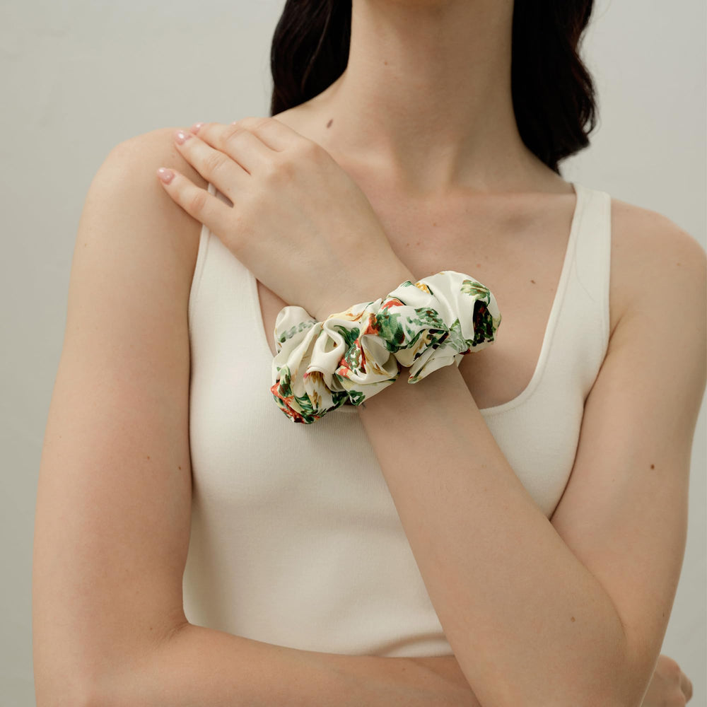 LilySilk silk scrunchie beside a ruler showing stretch and size fit