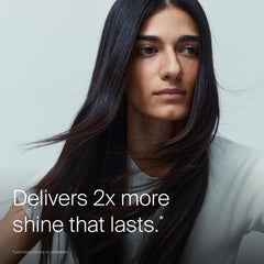 Living Proof applying gloss to wet hair for smoother detangling benefit