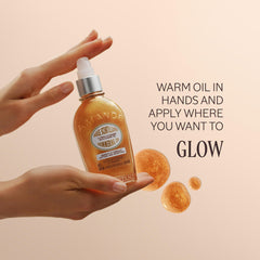 Close-up texture of L'OCCITANE almond shimmering oil showing fine luminous particles and smooth finish