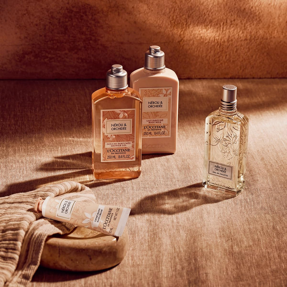L'OCCITANE bottle beside bathtub and towel depicting a refreshing shower routine