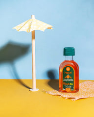 Lola Pinga bottle held in hand showing 1.69 fl oz travel size and convenience for on-the-go use