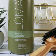 Loma liter bottle beside hand to show 33 ounce size suitable for frequent use