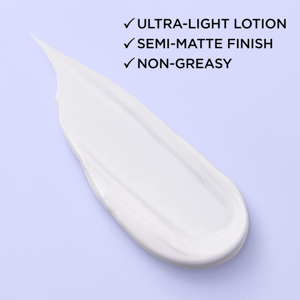 L'Oreal Paris moisturizer on hand demonstrating smooth, non-greasy finish
