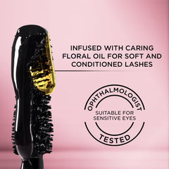 L'Oreal Paris tube next to fingertip for size comparison and portability benefit